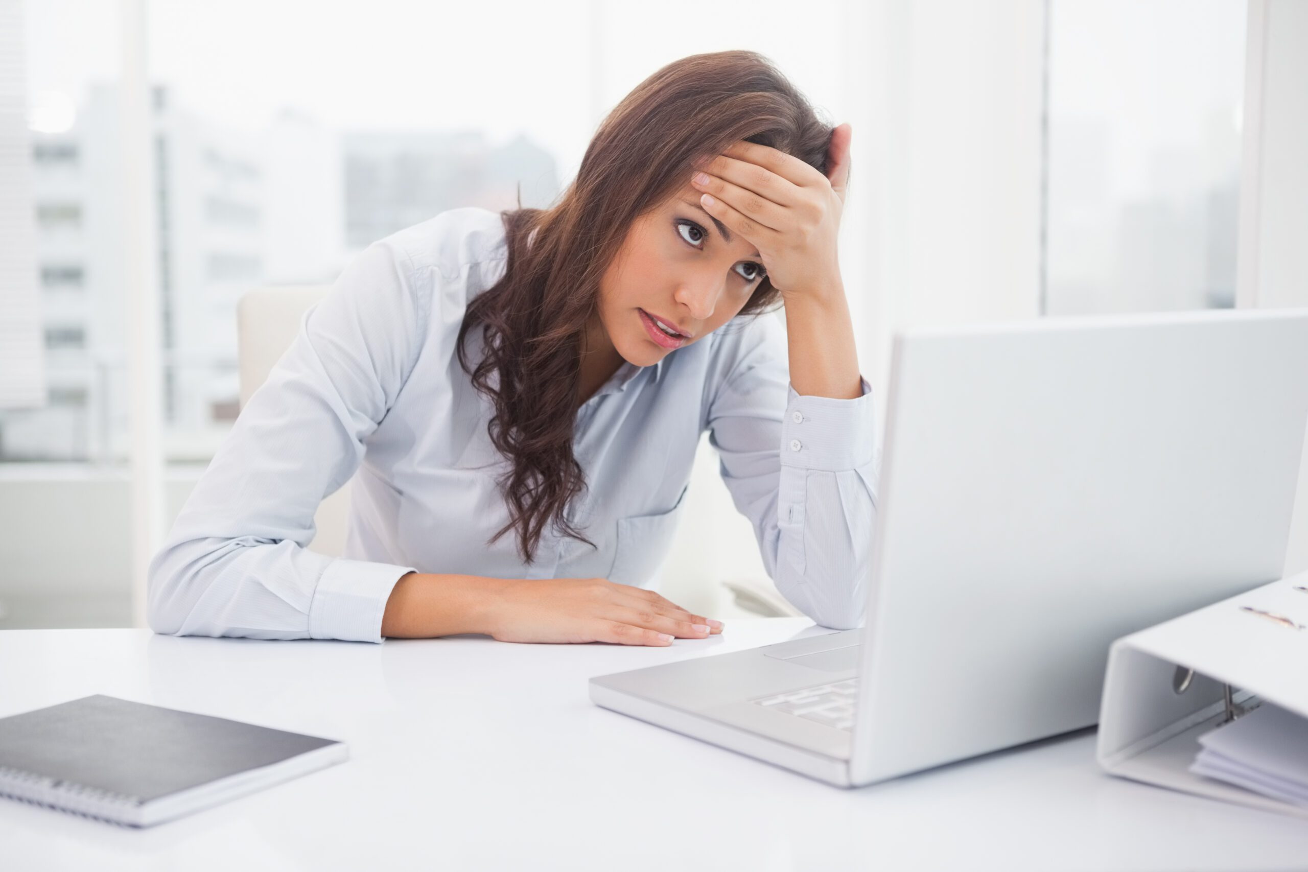 Stressed businesswoman working at her desk